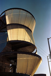 Low angle view of water tower against clear blue sky