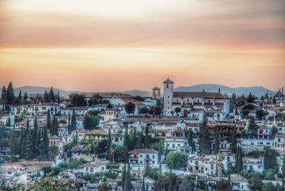 Cityscape against sky at sunset