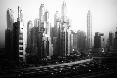 Aerial view of modern buildings in city against sky