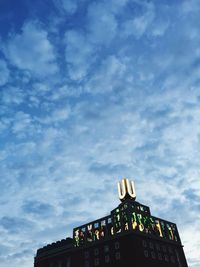 Low angle view of building against cloudy sky