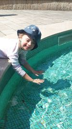 High angle view of smiling boy in swimming pool