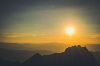 Scenic view of silhouette mountains against sky during sunset