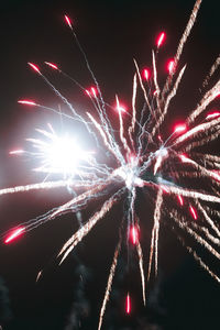 Low angle view of firework display at night