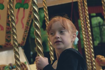 Low angle view of girl on carousel