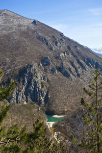 Scenic view of land and mountains against sky