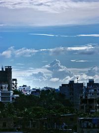 Buildings against cloudy sky