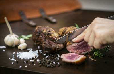 Close-up of person preparing food on cutting board