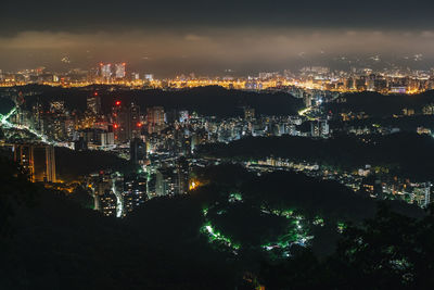 High angle view of illuminated buildings in city at night