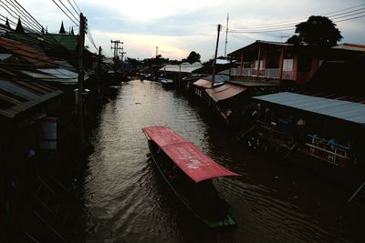 Canal amidst buildings against sky