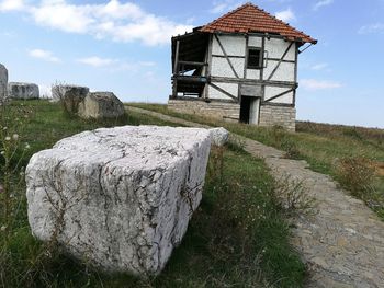 Lifeguard hut on grass against sky