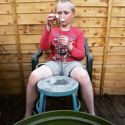 Full length of man sitting on chair