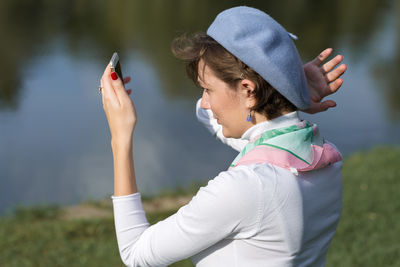 Side view of woman using mobile phone