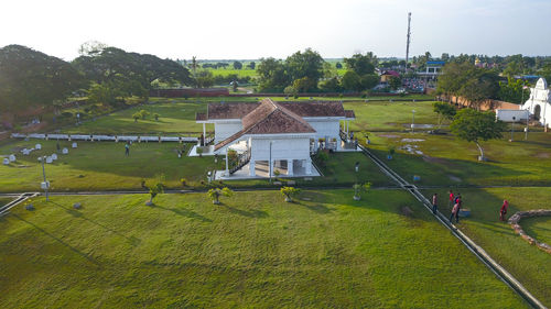 High angle view of house on field against sky