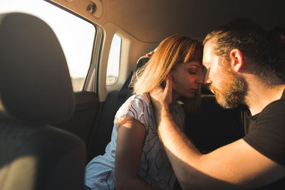 Young couple sitting in car