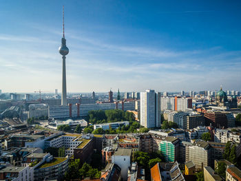 Fernsehturm with cityscape against sky