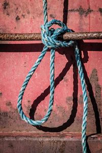 Close-up of rope tied on metal wall