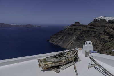 Santorini, greece, may 3, 2024. old boat on the roof of a house in firostani