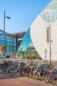 Bicycles parked on street against buildings