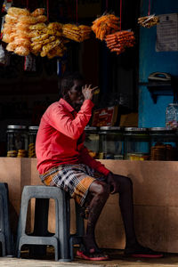 Man sitting on chair drinking tea