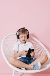 Full length of boy using mobile phone