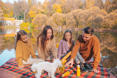 Group of people sitting in park during autumn