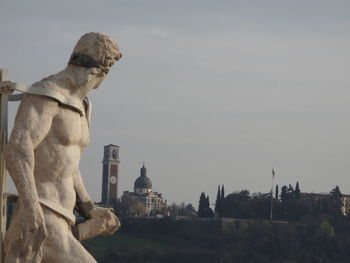 Statue against church