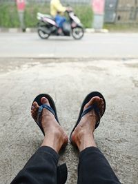 Low section of person standing on street