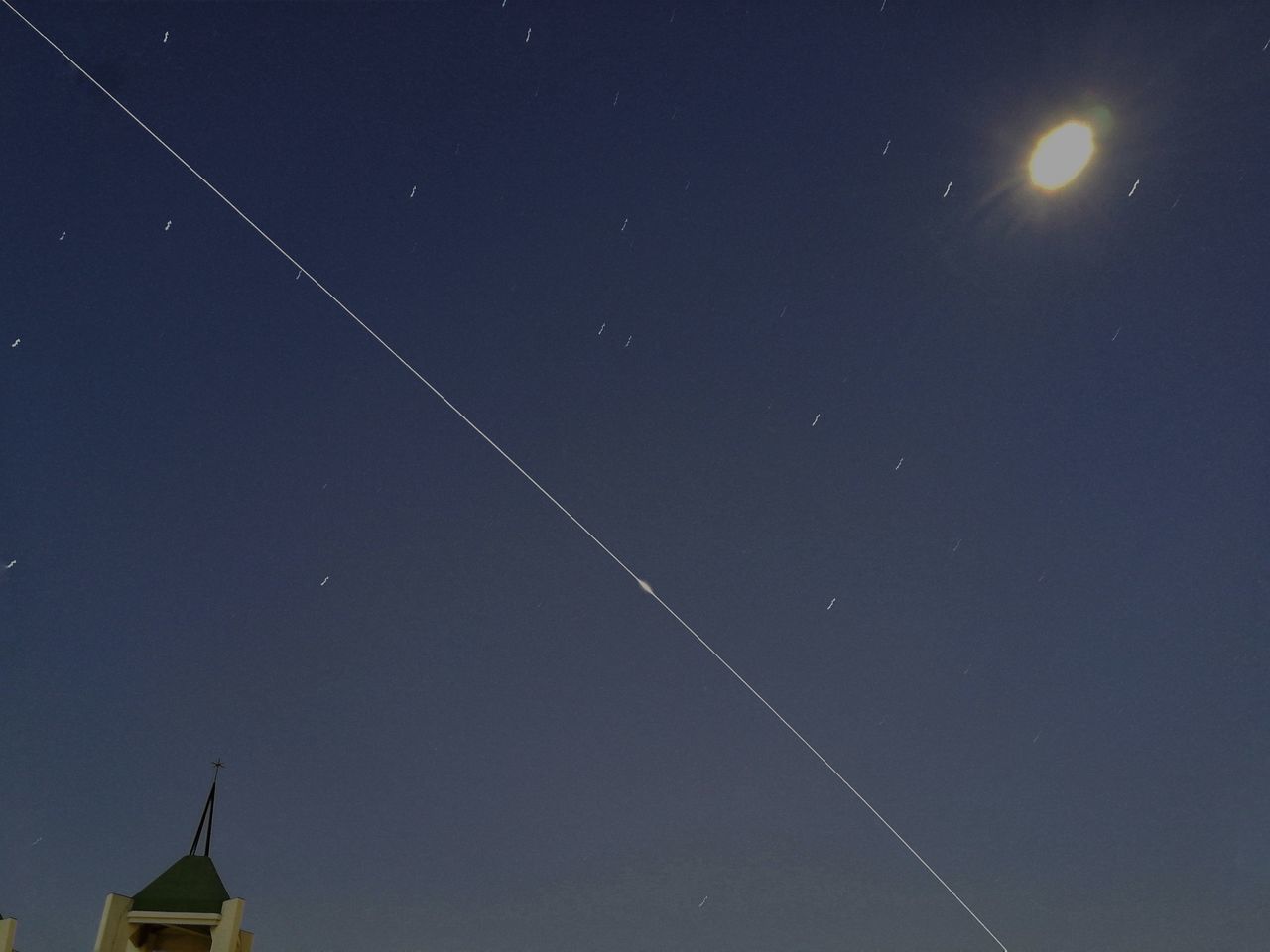 LOW ANGLE VIEW OF VAPOR TRAILS AT NIGHT