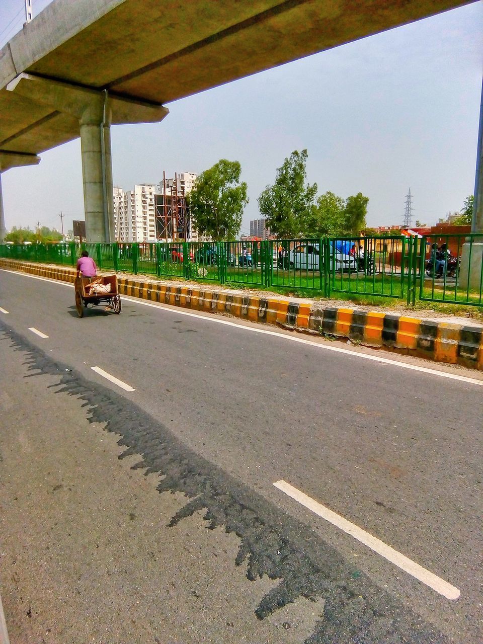 PEOPLE RIDING MOTORCYCLE ON ROAD IN CITY