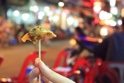 Cropped image of hand holding cigarette