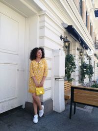 Full length of woman standing outside building