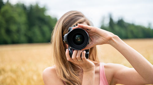 Portrait of woman photographing