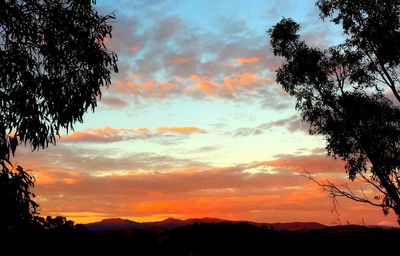 Silhouette of landscape against cloudy sky