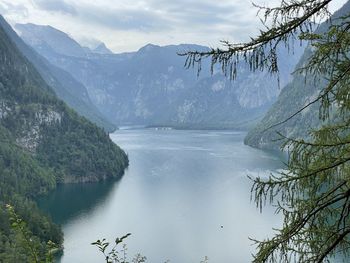 Scenic view of lake by mountains during winter