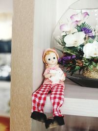 Full length of woman with toy standing against blue wall