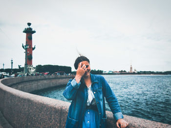 Woman standing at promenade against sky