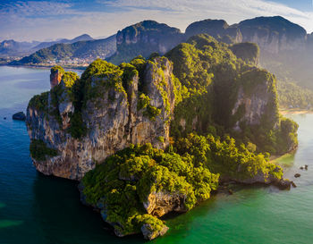 Rock formations by sea against sky