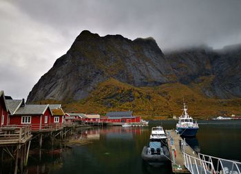 Boats moored in lake against sky