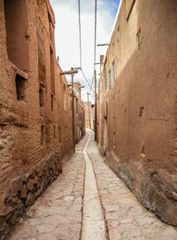 Alley amidst buildings against sky
