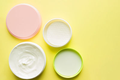 High angle view of multi colored candies against yellow background