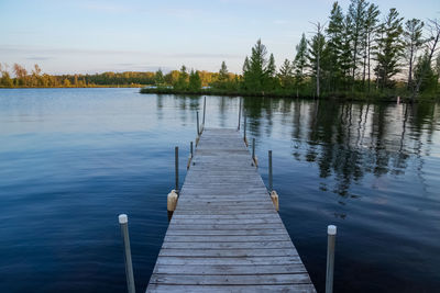 Pier over lake against sky