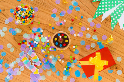 High angle view of multi colored candies on wooden table