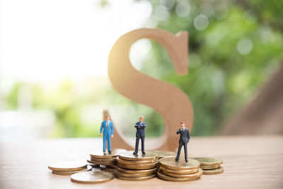 Figurines standing on coins