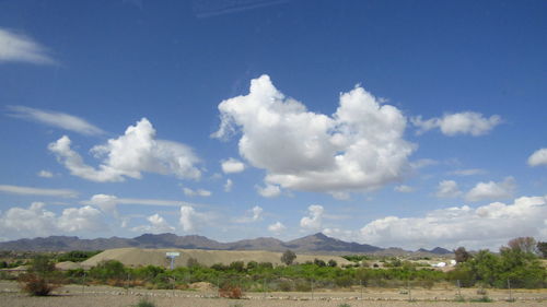 Countryside landscape against blue sky and clouds