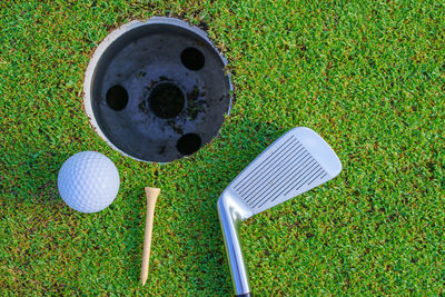 High angle view of golf equipment on grassy field