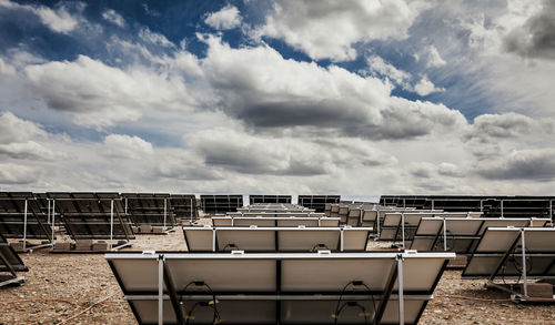 Solar panels on field against sky