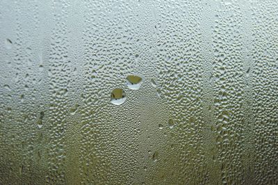 Full frame shot of raindrops on glass