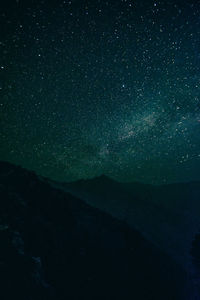 Scenic view of mountains against star field at night