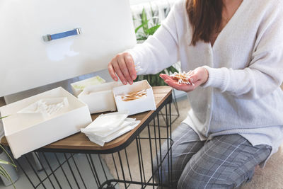 Midsection of woman using laptop