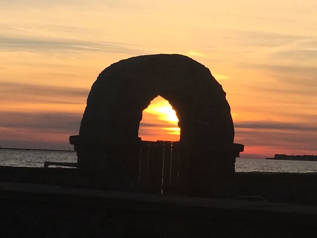 sunset, orange color, water, sky, sea, silhouette, built structure, architecture, scenics, horizon over water, tranquility, beauty in nature, cloud - sky, beach, arch, sun, tranquil scene, nature, idyllic, reflection